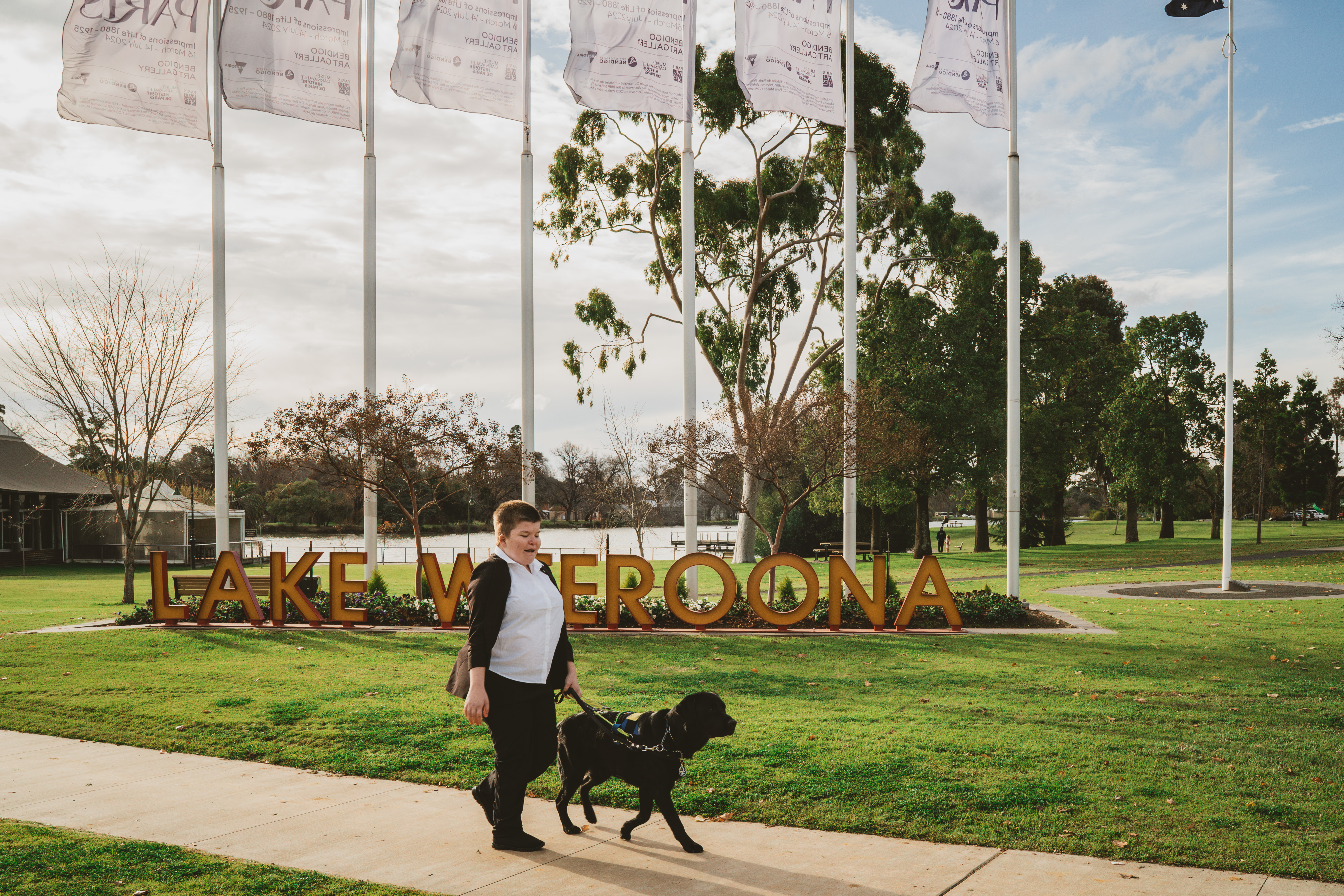 Alayna and her Seeing Eye Dog Joey going for a walk around a scenic lake