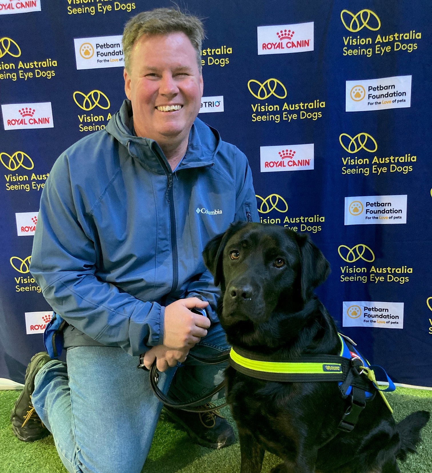 Dale kneeling next to his Seeing Eye Dog Yana