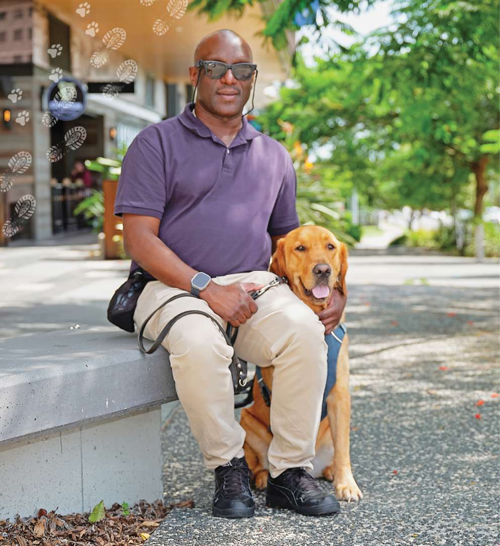 Nemoy is sitting with Seeing Eye Dog Benji beside him.