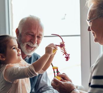 An older man is demonstrating something to y a younger girl