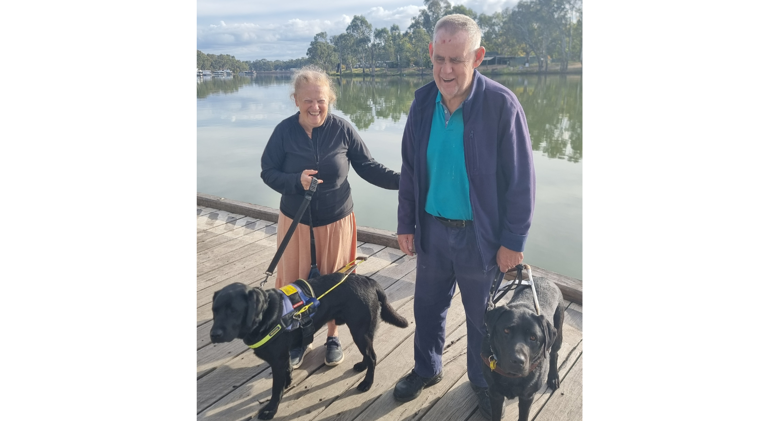 Warwick and Beverly with their Seeing Eye Dogs, beside the lake