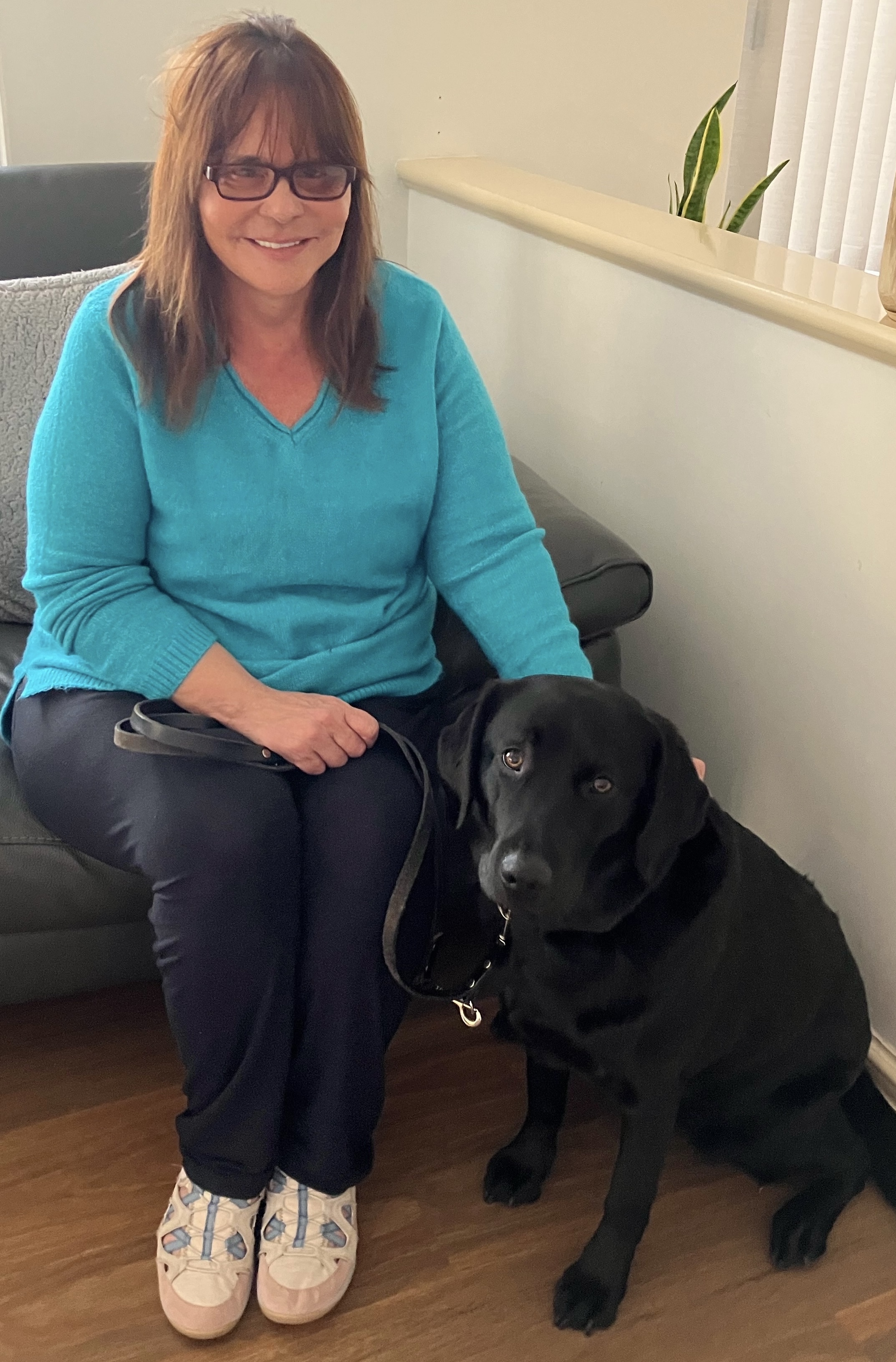 Michelle seated with her seeing eye dog Mirla