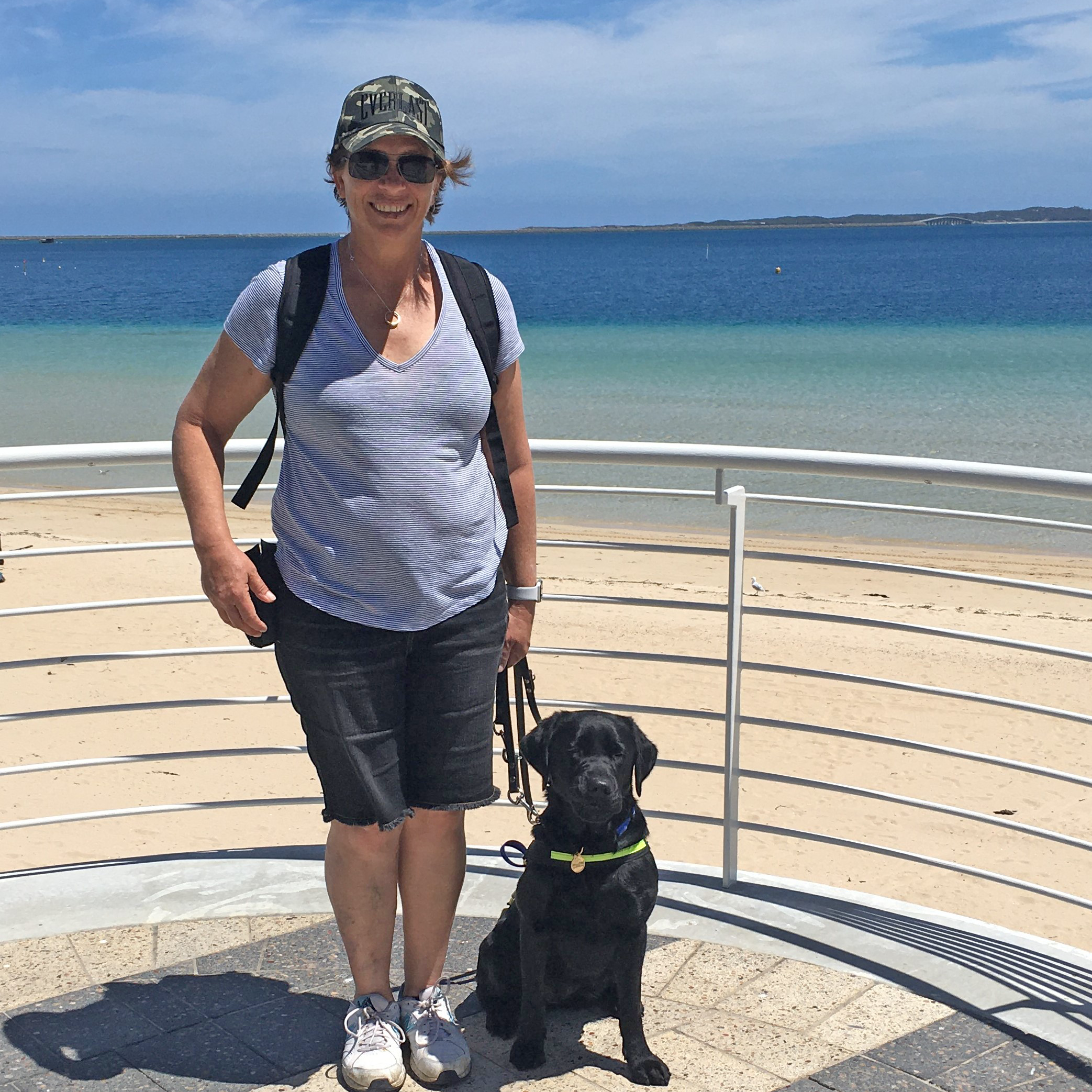Libby and Buffy the Seeing Eye Dog standing together at the beach