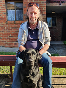 Seeing Eye Dog Hazel is sitting with Bruce