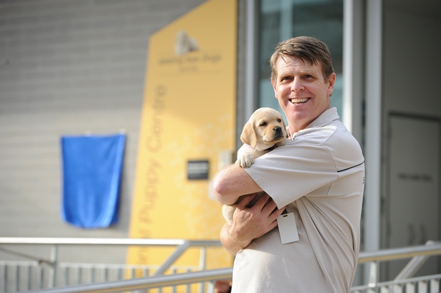 Trainer Stewart holding a Seeing Eye Dog Puppy