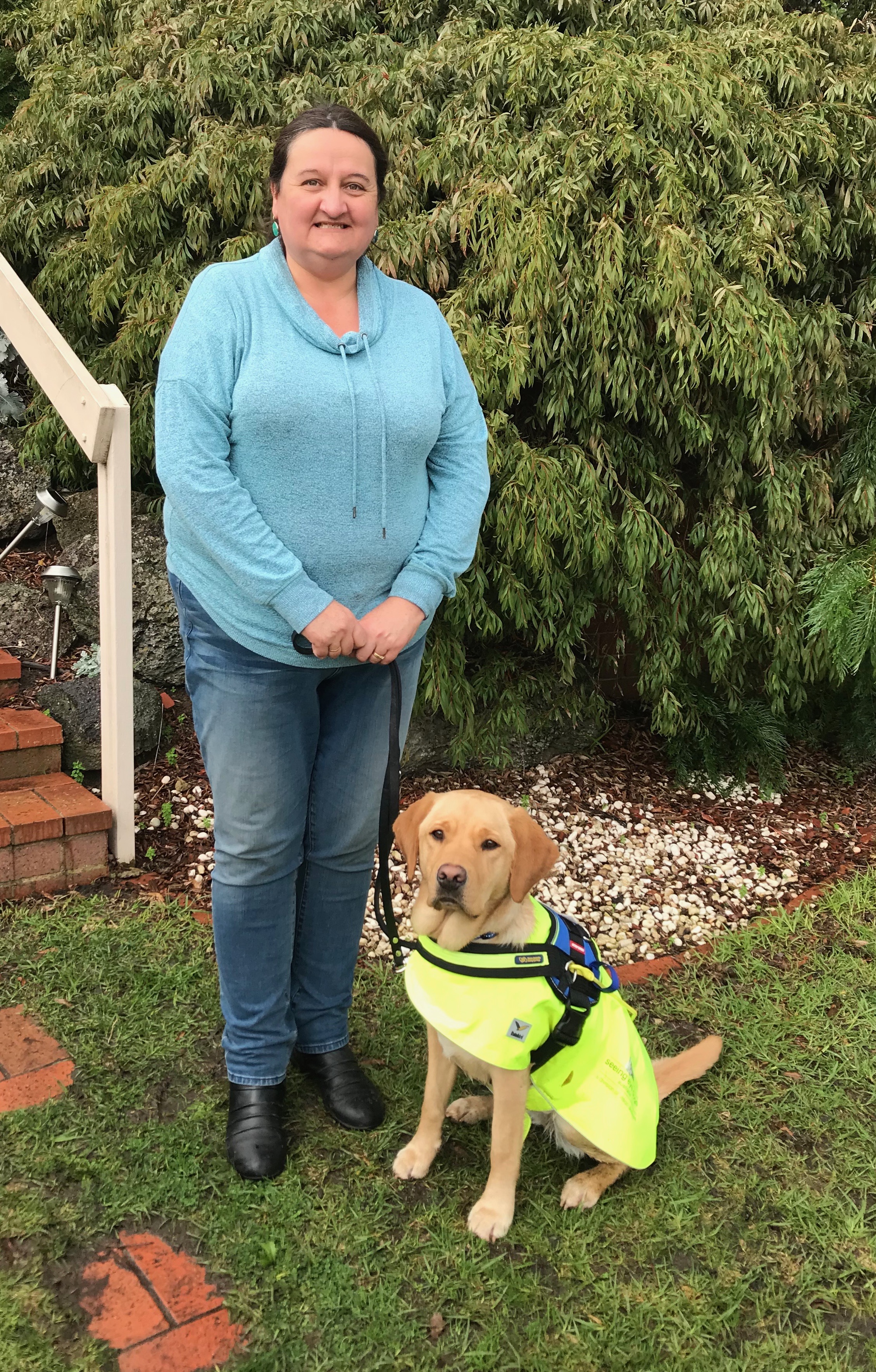 Kim stands with her Seeing Eye Dog Raya.