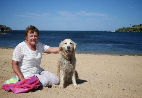 Jenny and her Seeing Eye Dog Goldie enjoy some down time at the beach