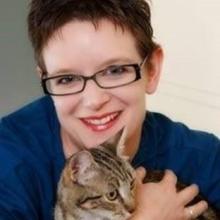 Dr Trepheena Hunter Dr Trepheena Hunter smiles at camera whilst hugging her cat